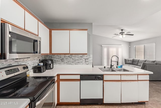 4741 N 85th Ave, Phoenix, AZ 85037 - kitchen with appliances with stainless steel finishes, a sink, white cabinetry, light countertops, and decorative backsplash