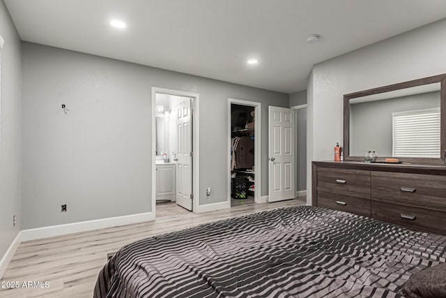 4741 N 85th Ave, Phoenix, AZ 85037 - bedroom with light wood-style floors, a spacious closet, recessed lighting, baseboards, and ensuite bath