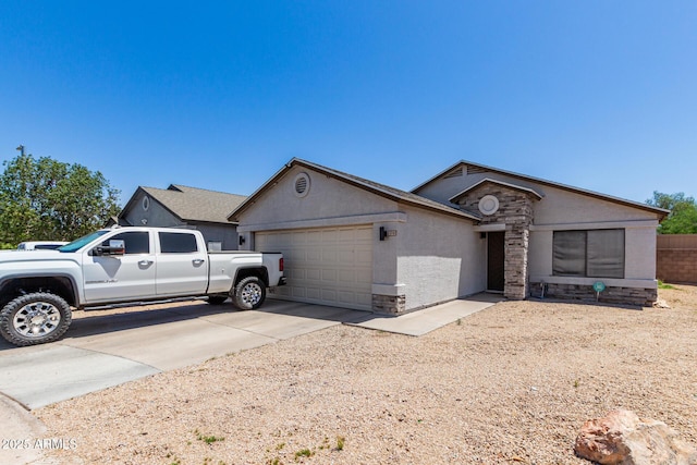 4741 N 85th Ave, Phoenix, AZ 85037 - single story home with an attached garage, driveway, stucco siding, and stone siding