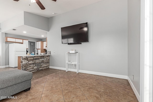4741 N 85th Ave, Phoenix, AZ 85037 - tiled living area with ceiling fan and baseboards