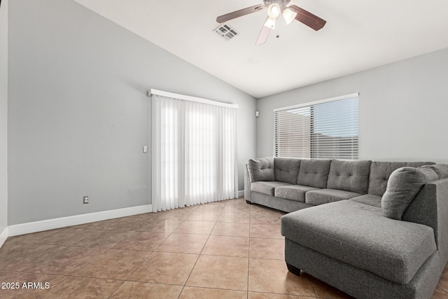 4741 N 85th Ave, Phoenix, AZ 85037 - living room featuring healthy amount of natural light, vaulted ceiling, ceiling fan, light tile patterned floors, and baseboards