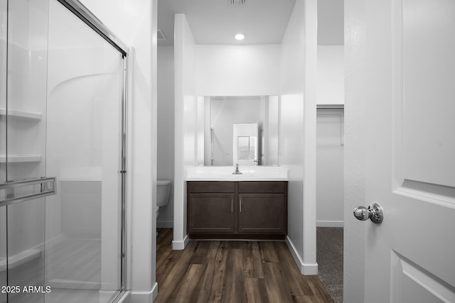 24606 W St Catherine Ave, Buckeye, AZ 85326 - bathroom featuring a shower stall, vanity, baseboards, and wood finished floors