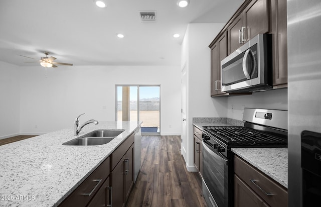 24606 W St Catherine Ave, Buckeye, AZ 85326 - kitchen with appliances with stainless steel finishes, dark brown cabinets, a sink, and visible vents
