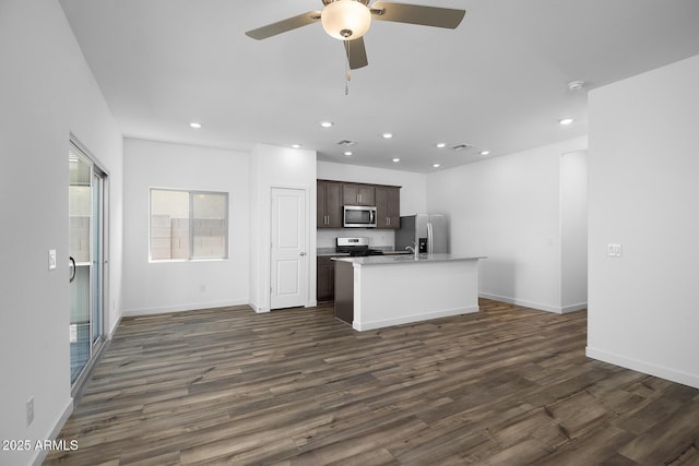 24606 W St Catherine Ave, Buckeye, AZ 85326 - kitchen featuring recessed lighting, stainless steel appliances, a ceiling fan, dark wood-type flooring, and a kitchen island with sink