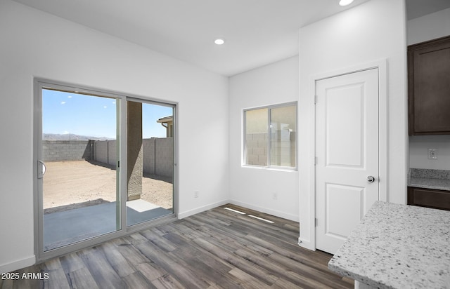 24606 W St Catherine Ave, Buckeye, AZ 85326 - unfurnished dining area with baseboards, dark wood-style floors, and recessed lighting