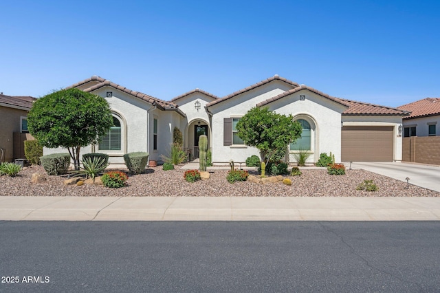 31320 N 54th Pl, Cave Creek, AZ 85331 - mediterranean / spanish-style home with a garage, driveway, stucco siding, and a tiled roof