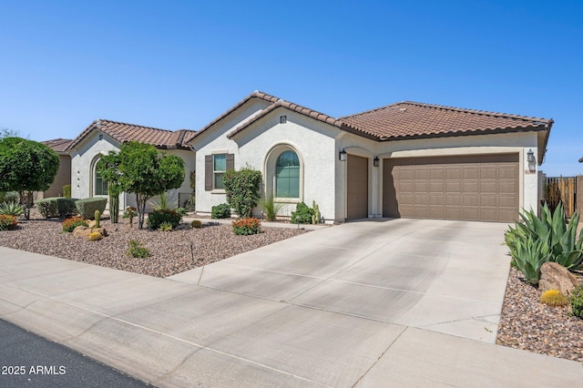 31320 N 54th Pl, Cave Creek, AZ 85331 - mediterranean / spanish house with an attached garage, concrete driveway, stucco siding, a tile roof, and fence