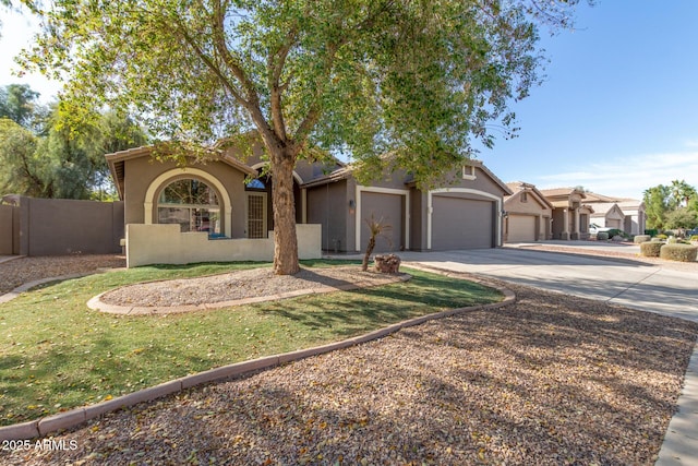 view of front of home featuring a fenced front yard, a garage, driveway, a residential view, and stucco siding