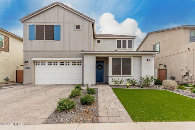 view of front of house with a garage and a front lawn