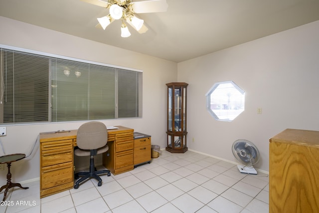 office area featuring a ceiling fan, light tile patterned flooring, and baseboards