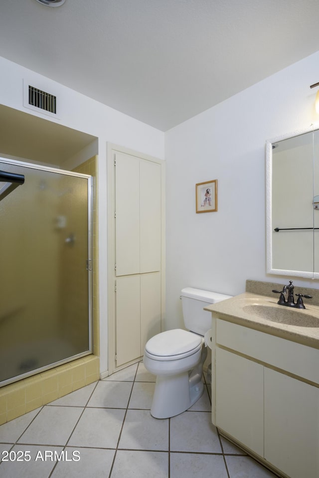 bathroom featuring visible vents, toilet, a stall shower, vanity, and tile patterned floors