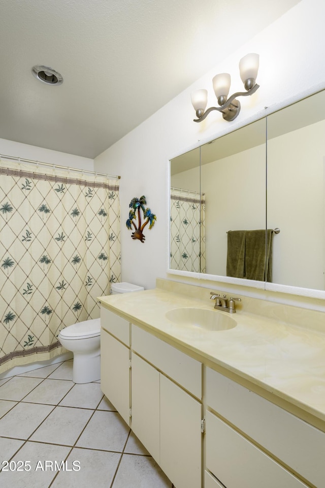 bathroom featuring vanity, toilet, and tile patterned floors