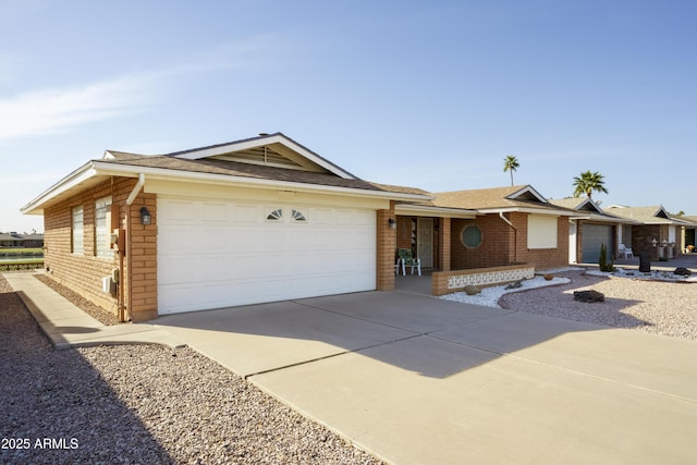 ranch-style home featuring concrete driveway, brick siding, and an attached garage