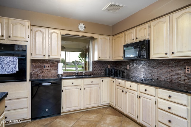 kitchen featuring black appliances, backsplash, a sink, and visible vents