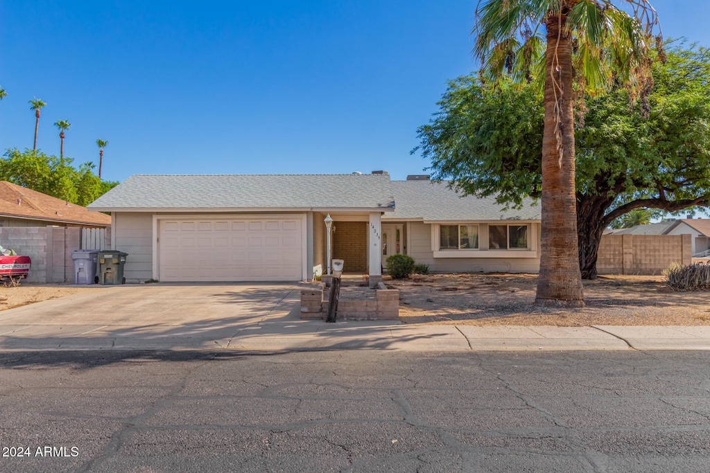 ranch-style home featuring a garage