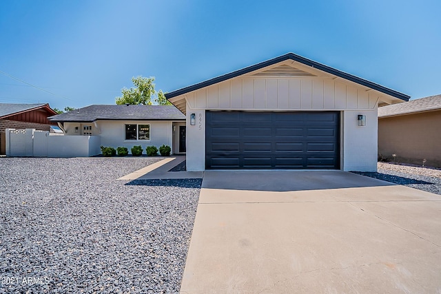single story home featuring concrete driveway and a garage