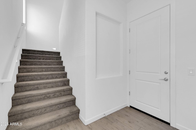 stairway featuring hardwood / wood-style floors