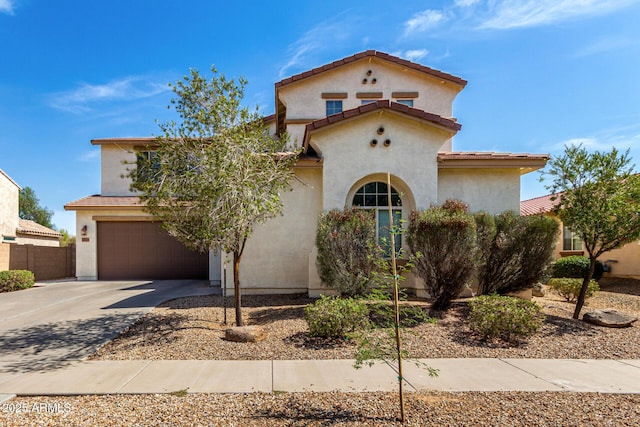 17153 W Gambit Trl, Surprise, AZ 85387 - mediterranean / spanish-style house featuring driveway, an attached garage, stucco siding, and a tile roof