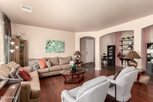 17153 W Gambit Trl, Surprise, AZ 85387 - living area featuring wood finished floors, arched walkways, and built in shelves