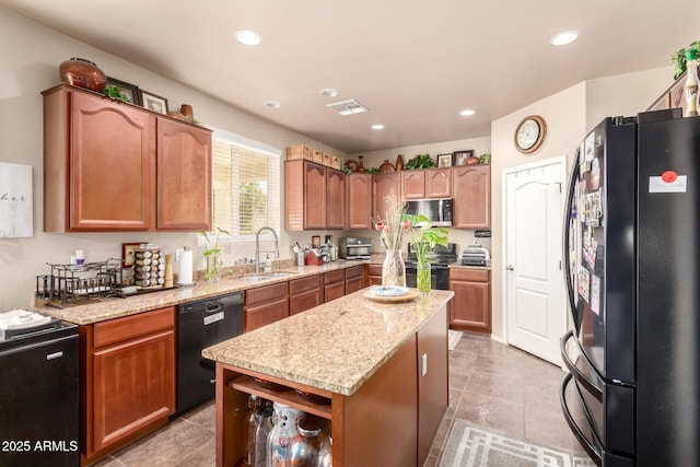 17153 W Gambit Trl, Surprise, AZ 85387 - kitchen featuring black appliances, light stone countertops, a kitchen island, recessed lighting, and light tile patterned flooring