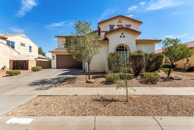 17153 W Gambit Trl, Surprise, AZ 85387 - mediterranean / spanish-style home featuring driveway, an attached garage, and stucco siding