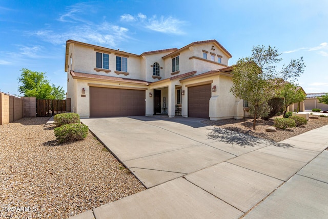 17153 W Gambit Trl, Surprise, AZ 85387 - mediterranean / spanish house featuring stucco siding, an attached garage, driveway, and a tiled roof