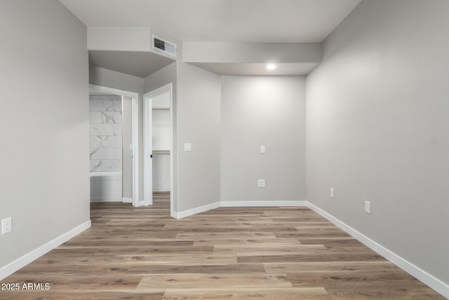 5303 N 7th St Unit 326, Phoenix, AZ 85014 - unfurnished room featuring baseboards and light wood finished floors