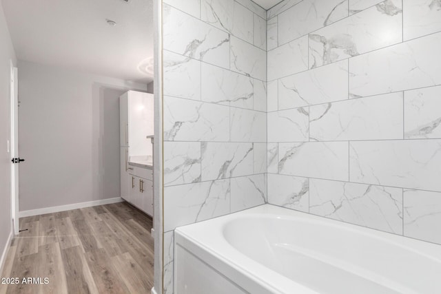 5303 N 7th St Unit 326, Phoenix, AZ 85014 - full bathroom with a tub to relax in, wood finished floors, and vanity