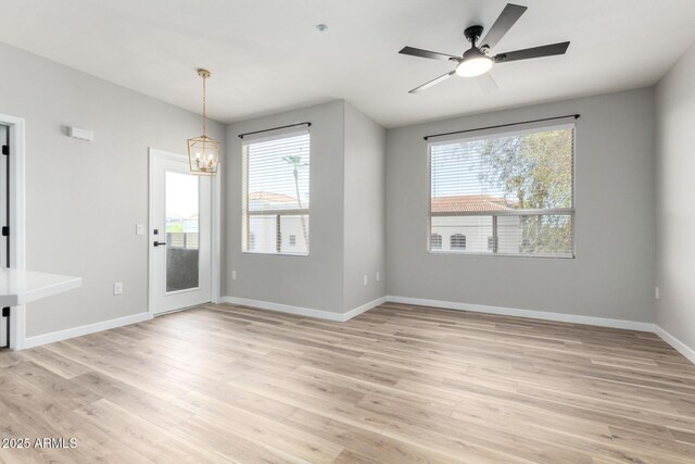 5303 N 7th St Unit 326, Phoenix, AZ 85014 - unfurnished room featuring a chandelier, light wood-type flooring, and ceiling fan