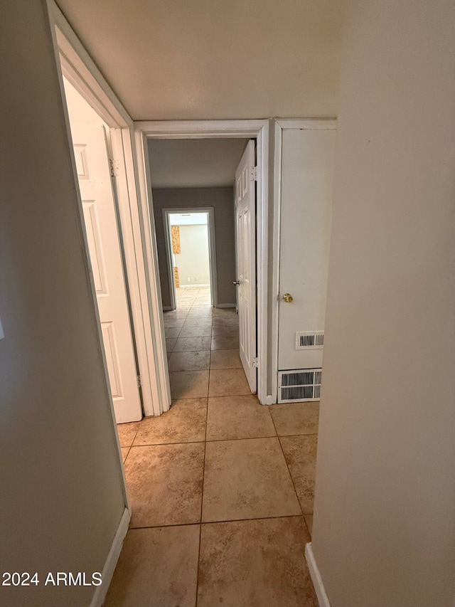 corridor with light tile patterned floors