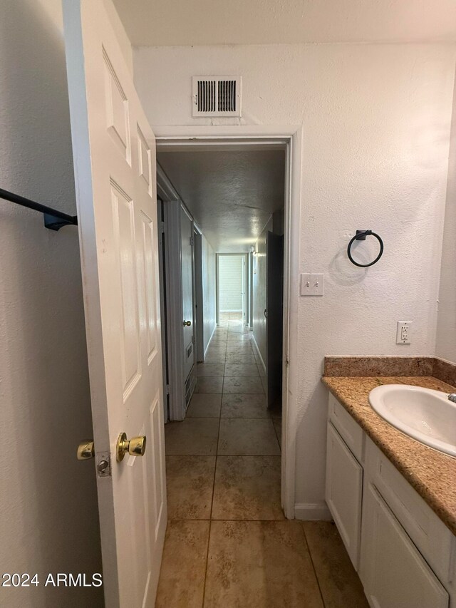 bathroom with vanity and tile patterned flooring