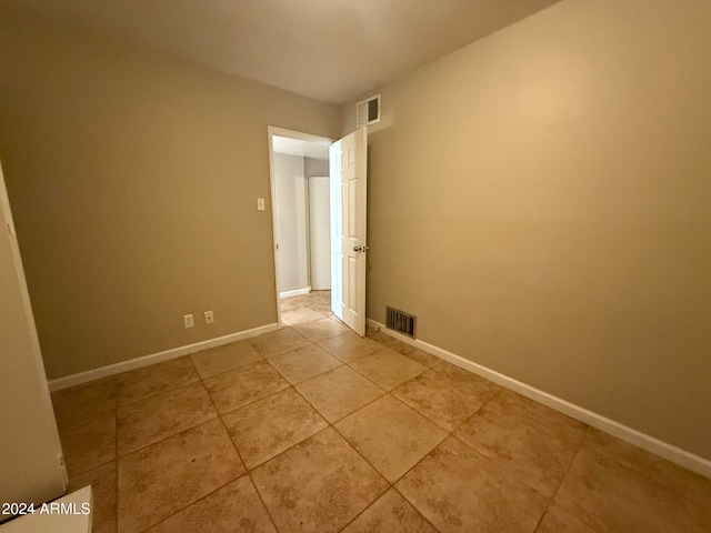 spare room with light tile patterned floors