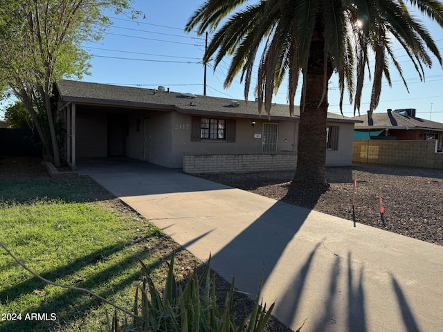 view of front of house with a front lawn and a carport