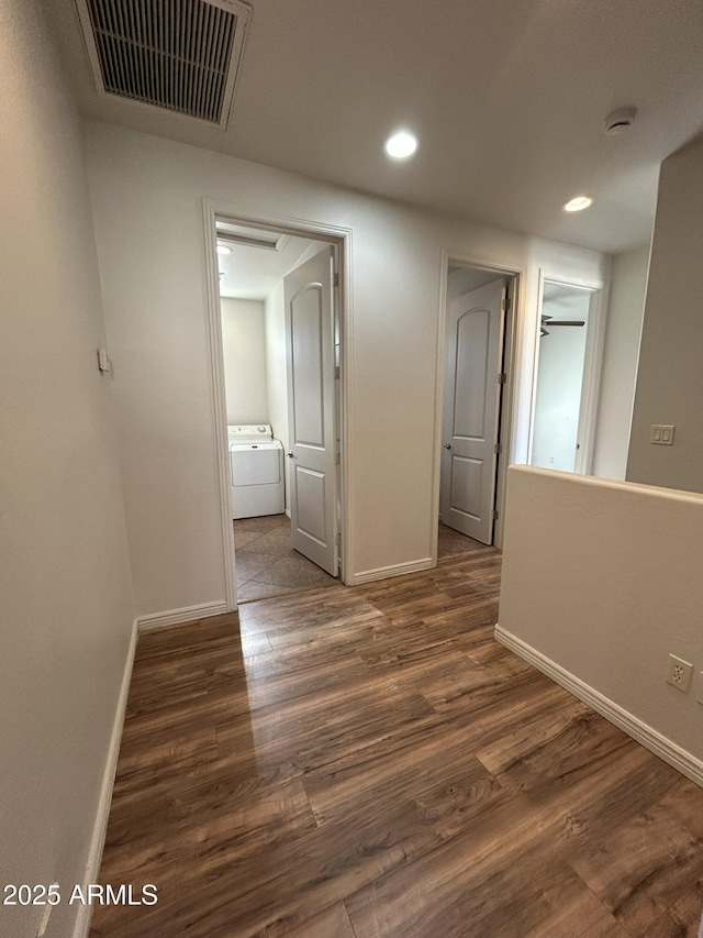 hall featuring washer / clothes dryer and dark hardwood / wood-style floors