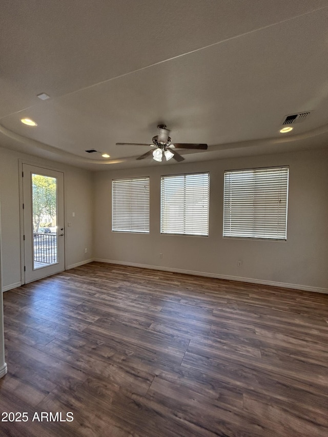 empty room featuring ceiling fan and dark hardwood / wood-style flooring