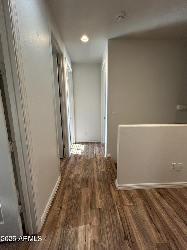 hallway with dark hardwood / wood-style flooring