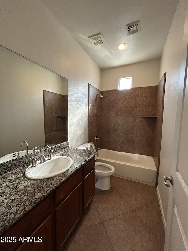 full bathroom featuring tiled shower / bath, vanity, toilet, and tile patterned flooring