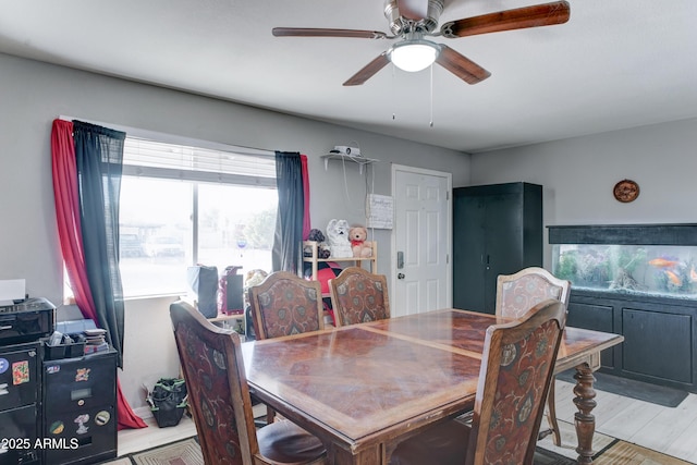 dining area with wood finished floors and a ceiling fan