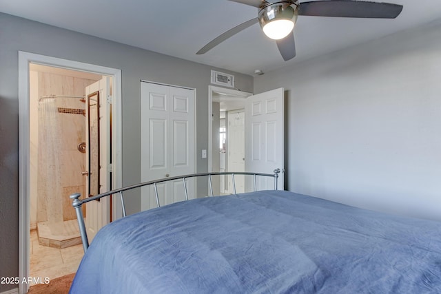 tiled bedroom with visible vents, ensuite bath, and ceiling fan