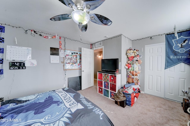 bedroom with a closet, visible vents, ceiling fan, and carpet