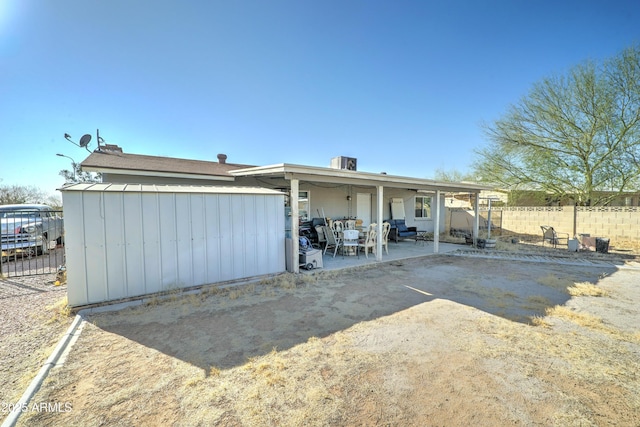 rear view of property with a patio area and fence