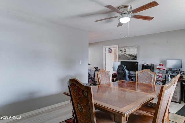 dining space featuring light wood-type flooring and ceiling fan