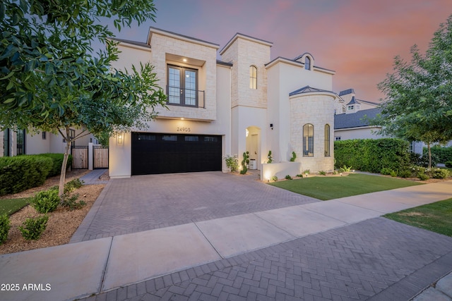 24905 S 206th Pl, Queen Creek, AZ 85142 - view of front of home featuring stone siding, decorative driveway, a garage, stucco siding, and french doors