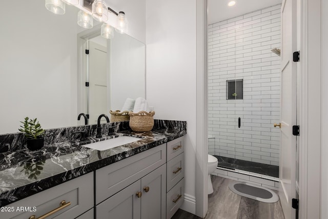 24905 S 206th Pl, Queen Creek, AZ 85142 - bathroom with vanity, toilet, a shower stall, wood finished floors, and a baseboard radiator