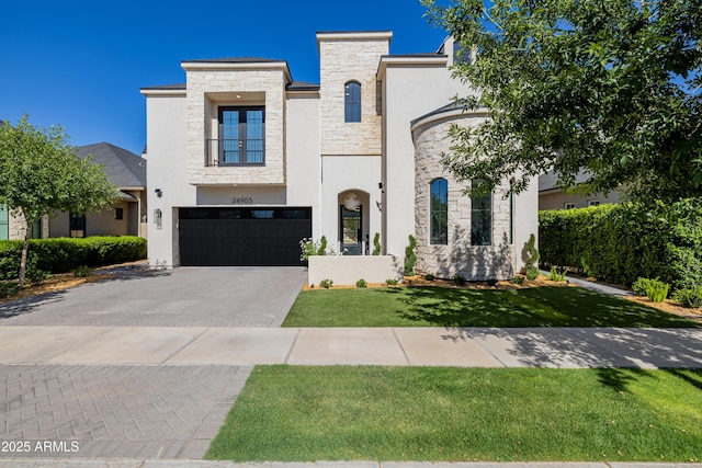 24905 S 206th Pl, Queen Creek, AZ 85142 - view of front facade with stone siding, an attached garage, stucco siding, driveway, and french doors