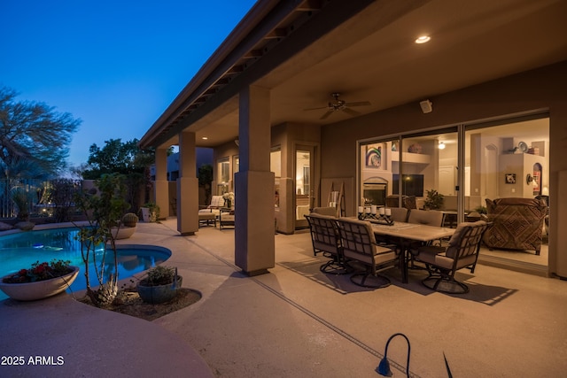 patio terrace at dusk featuring an outdoor hangout area and ceiling fan