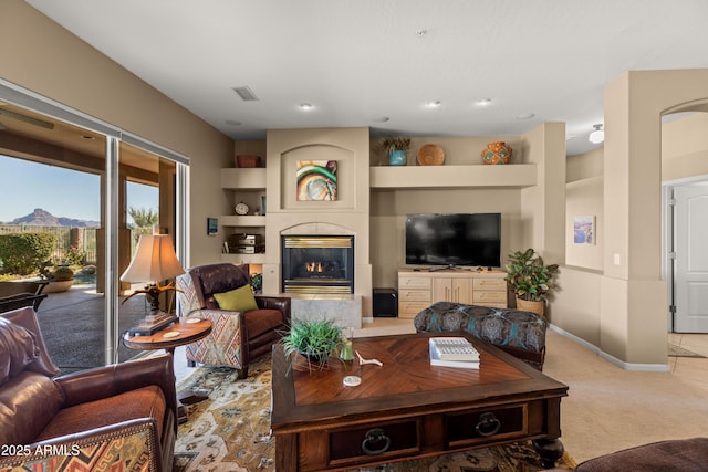 carpeted living room featuring built in features