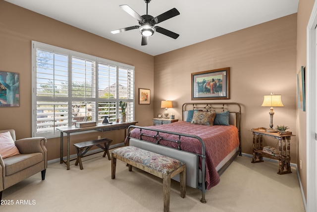 bedroom featuring ceiling fan and light colored carpet