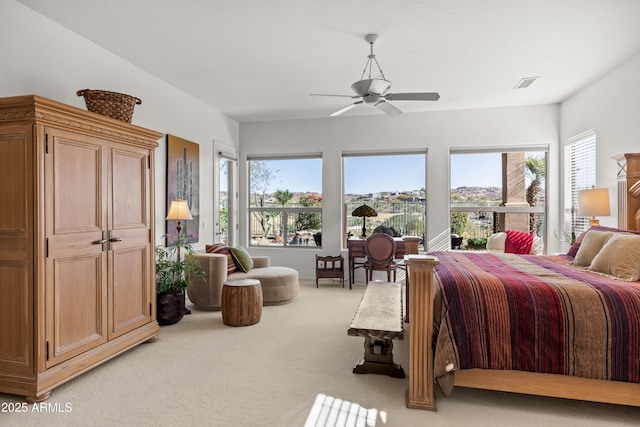 bedroom featuring ceiling fan and light colored carpet