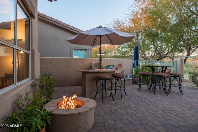 view of patio featuring an outdoor bar and an outdoor fire pit